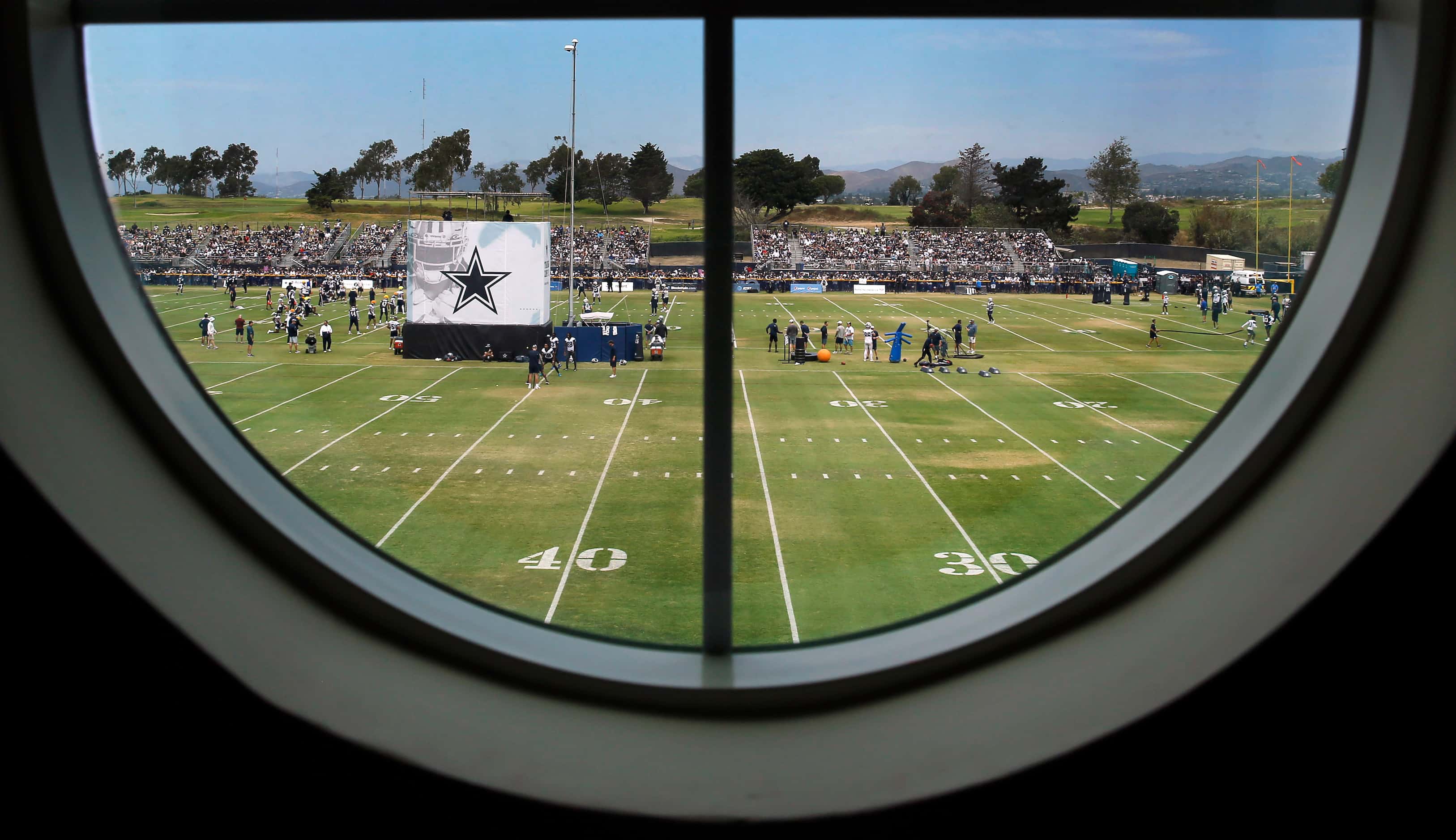 The Dallas Cowboys training camp is seen through a porthole window in Michelle Payne’s...