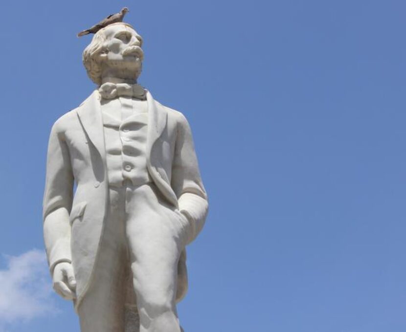 
A pigeon perches on a statue in a Havana square. 
