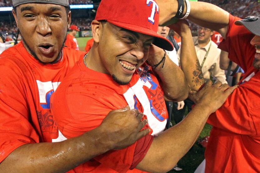 Texas'  Elvis Andrus, Nelson Cruz and CJ Wilson celebrate after Game 6 of the American...