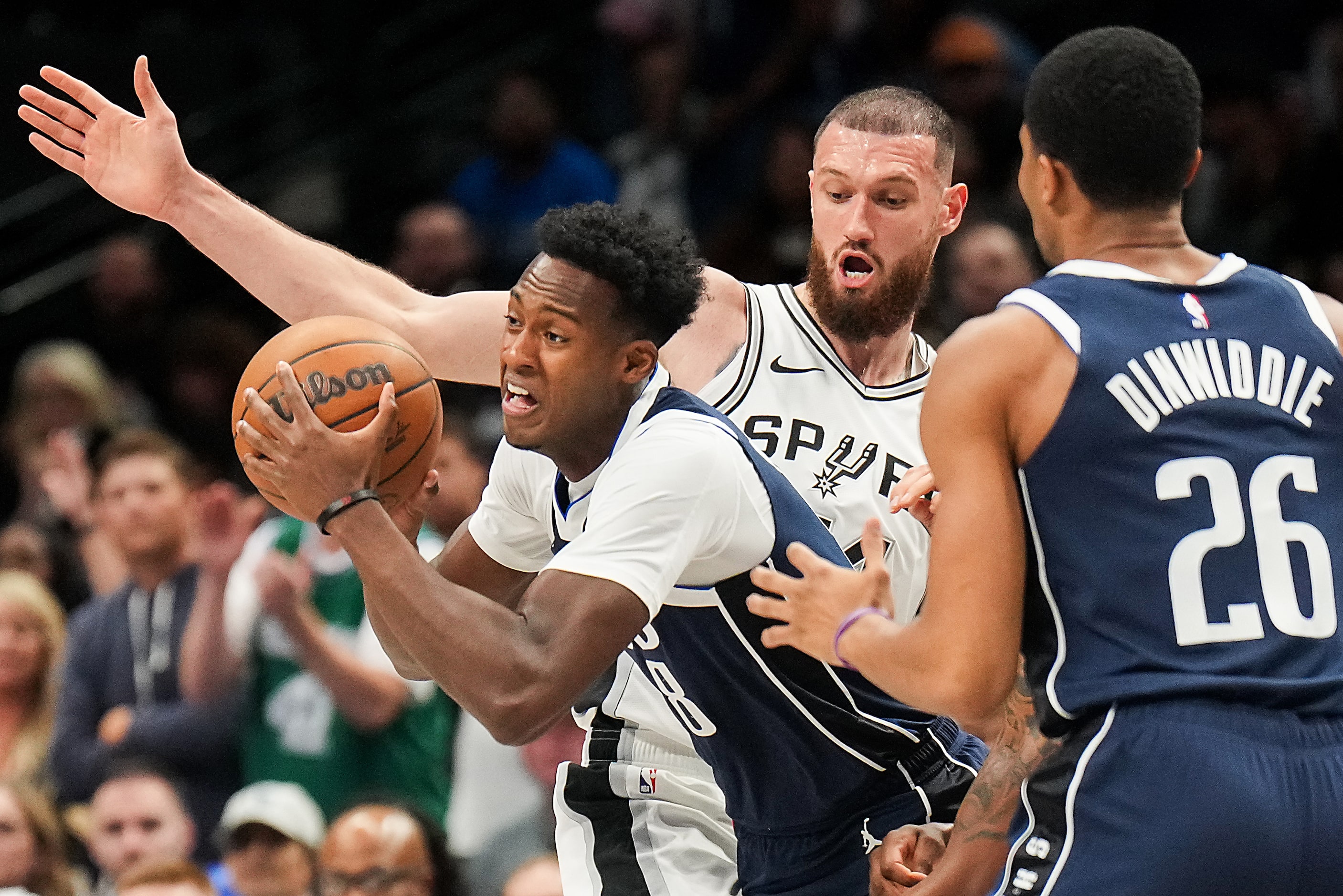 Dallas Mavericks forward Olivier-Maxence Prosper (8) pushes past San Antonio Spurs forward...