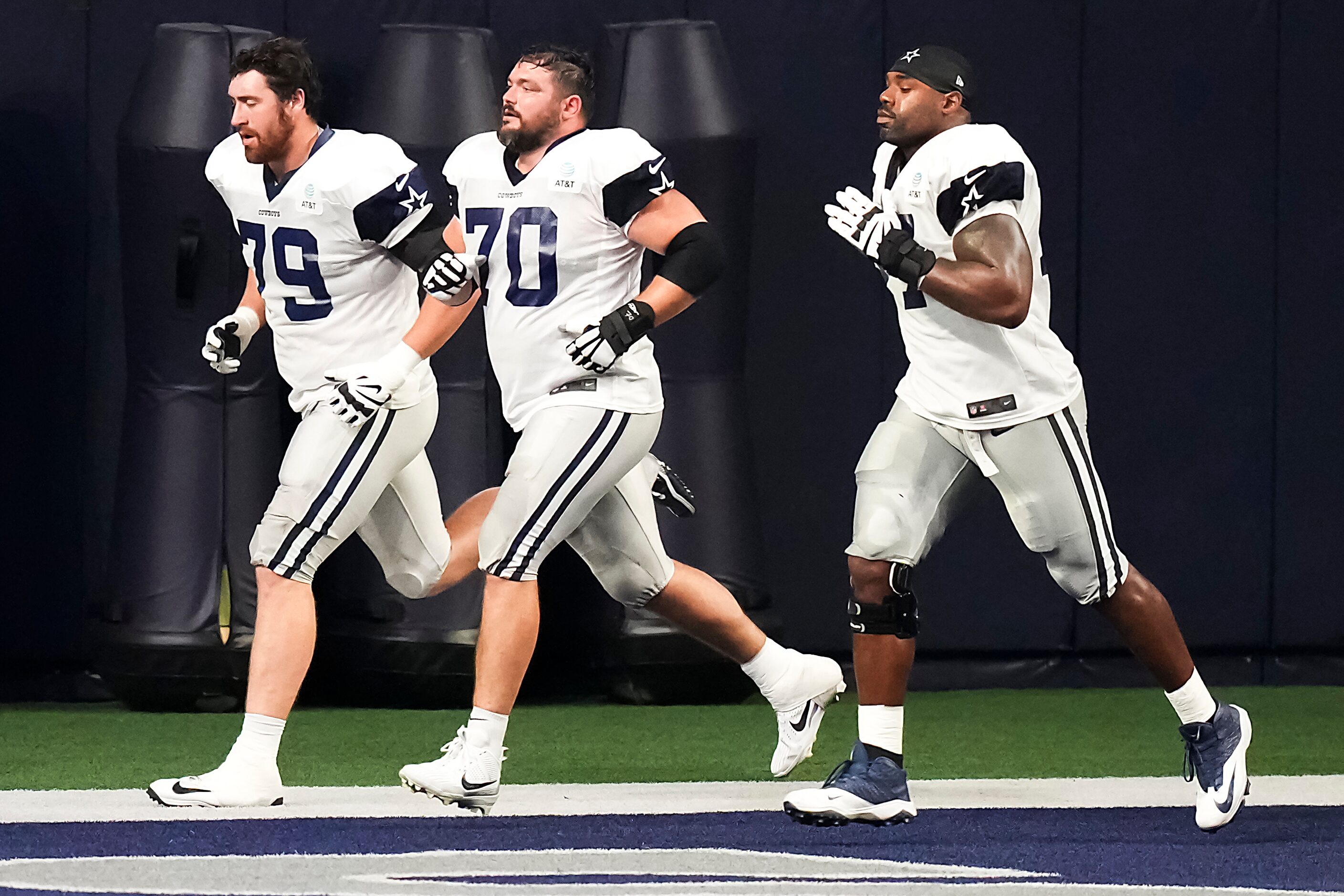 Dallas Cowboys offensive lineman Zack Martin (70) runs with Matt Waletzko (79) and Tyron...