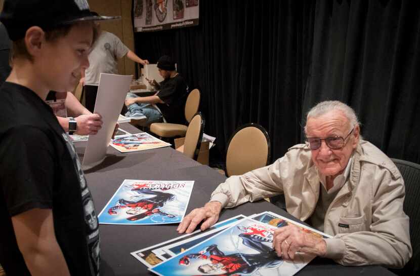 Stan Lee pauses while signing an autograph for Presley Caroll at the Marvelous Nerd Year's...