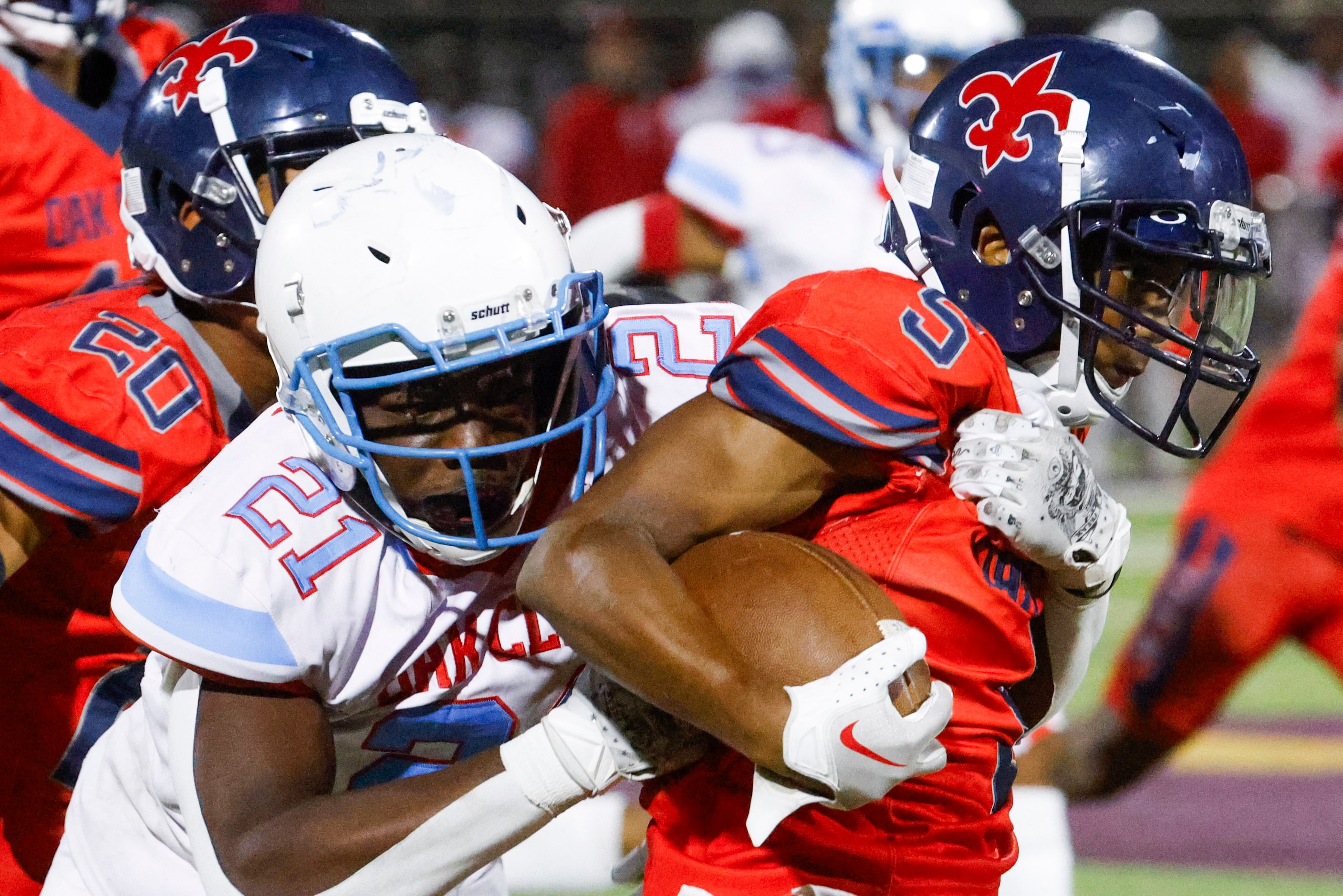 Carter high’s Damarion Boozer (left) tackles Kimball highs Camrin Jackson during the second...