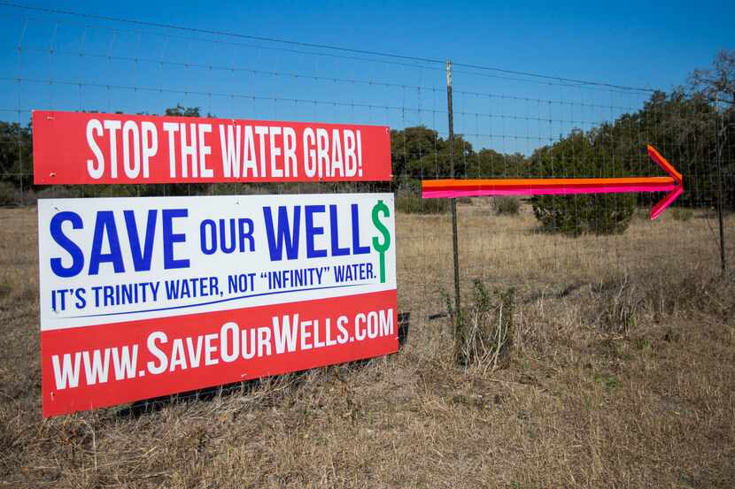 Signs along FM 3237 near Driftwood point out the site of a test well. Wells on surrounding...