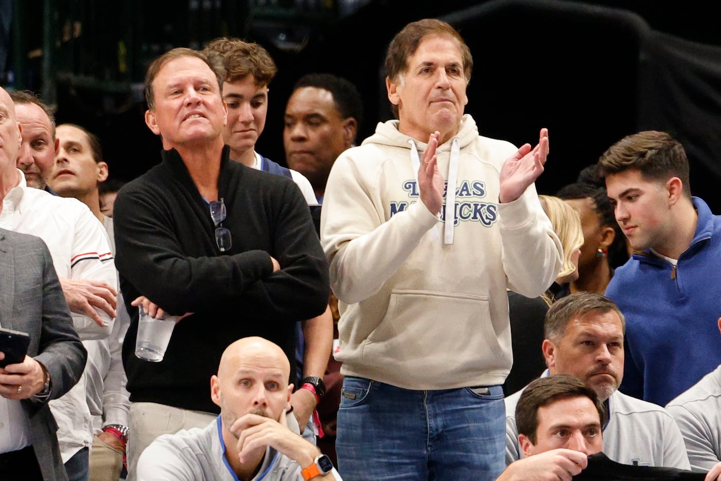 Dallas Mavericks owner Mark Cuban, center, watches his players during the first half of an...