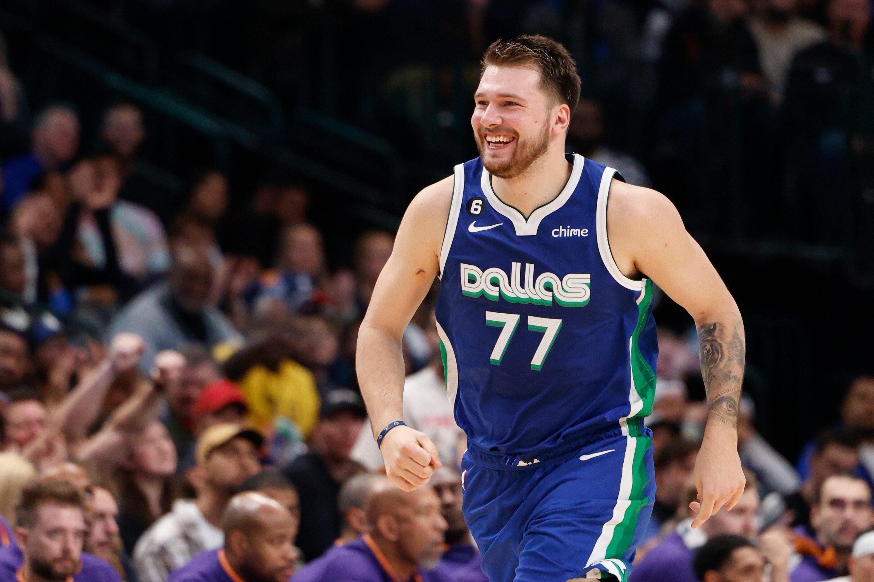 Dallas Mavericks guard Luka Doncic (77) smiles after hitting a three-point shot during the...