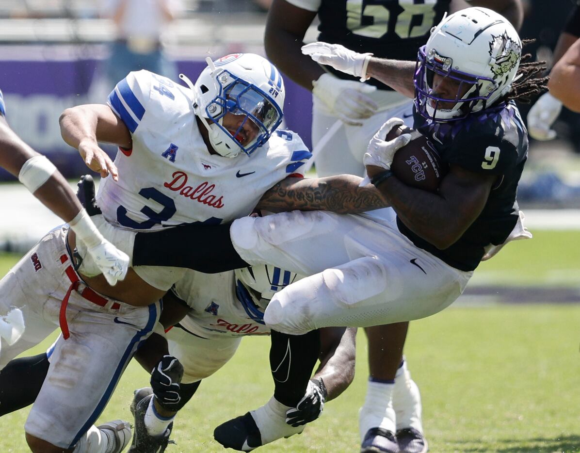 TCU Horned Frogs running back Emani Bailey (9) is tackled by Southern Methodist Mustangs...