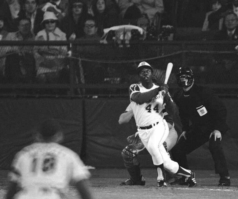  In this April 8, 1974, photo, Atlanta Braves' Hank Aaron eyes the flight of the ball after...