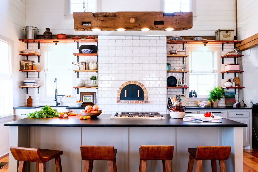 Bar stools provide a front-row seat to all the action in the kitchen, which is sure to...