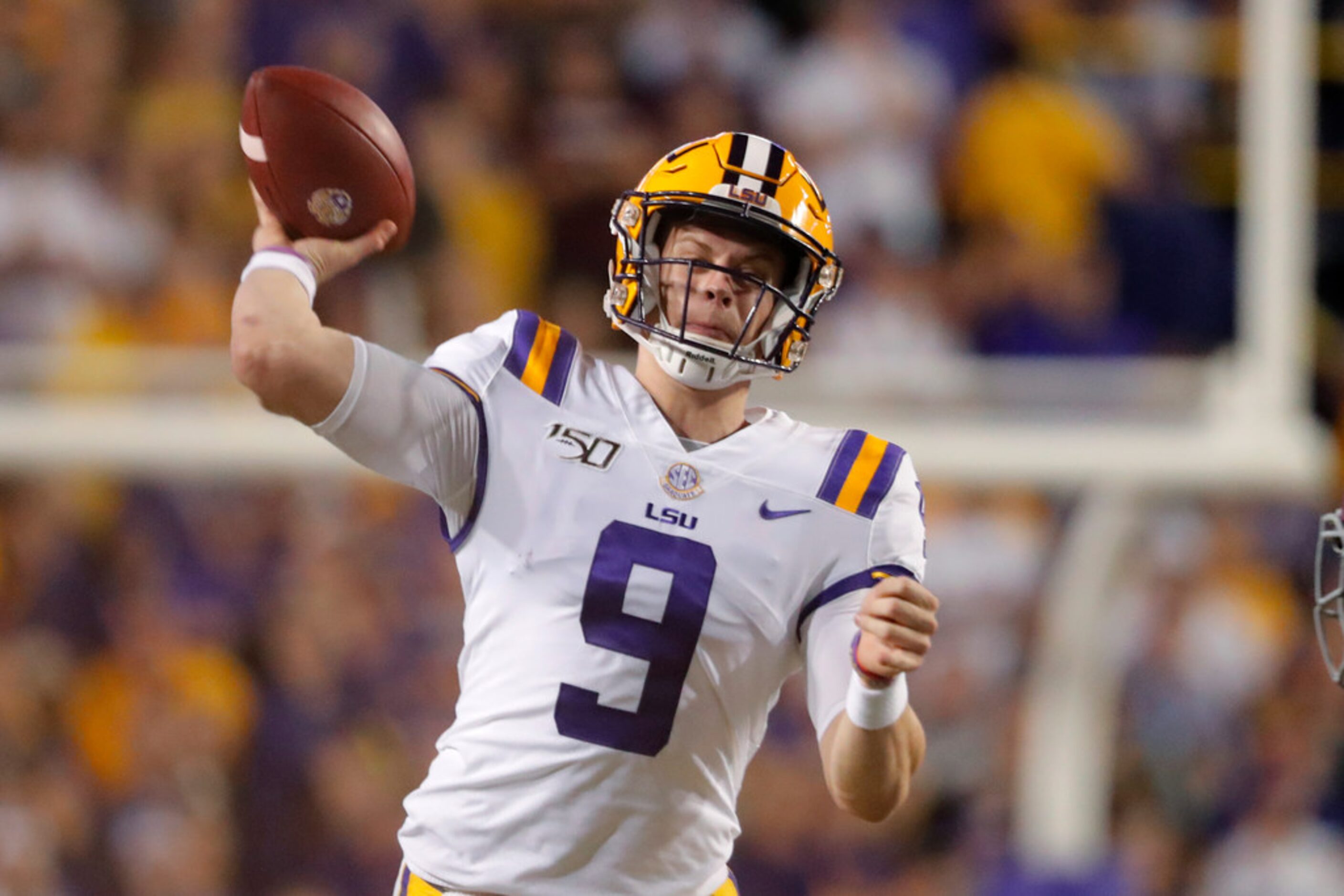 LSU quarterback Joe Burrow (9) throws a pass during the first half of an NCAA college...