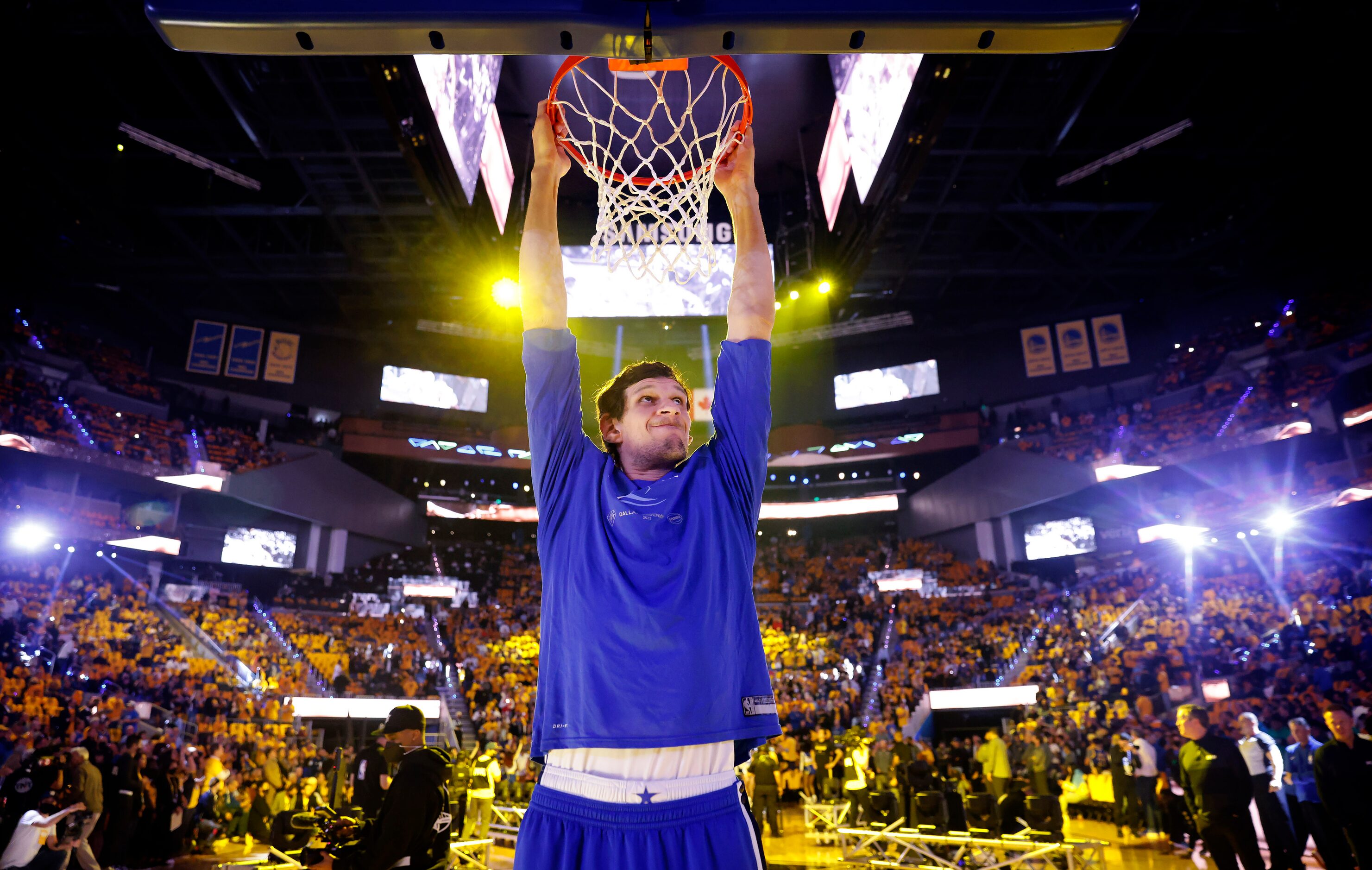 Dallas Mavericks center Boban Marjanovic (51) stretches by reaching for the rim before they...