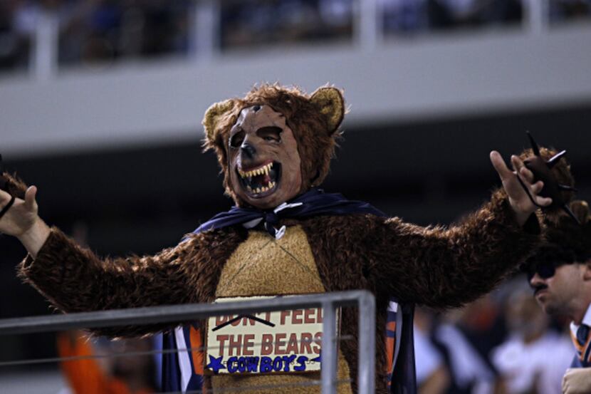 A Chicago fan dressed as a bear taunts Dallas Cowboys fans during the first half of a 34-18...