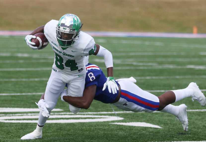 North Texas wide receiver Jaelon Darden (84) is tackled by Louisiana Tech safety DaMarion...