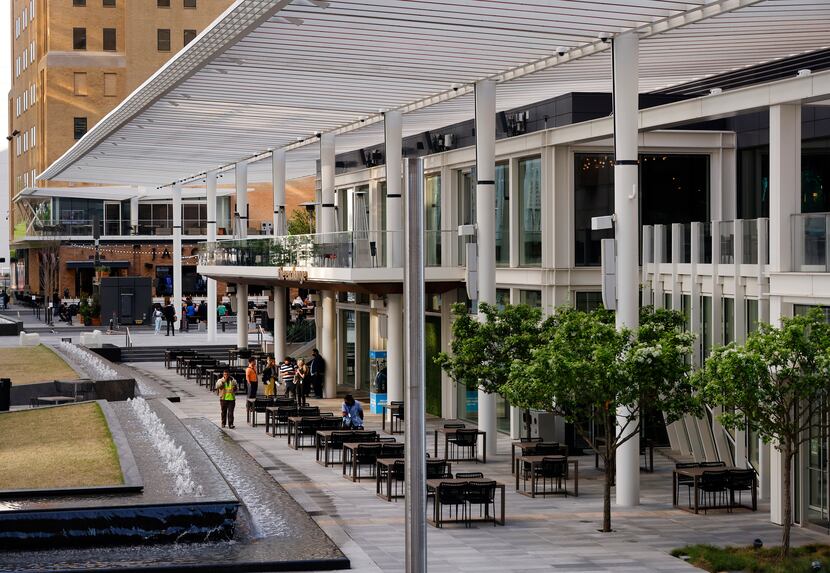 Steel trellises cover the outdoor dining area of the The Exchange food hall in the new AT&T...