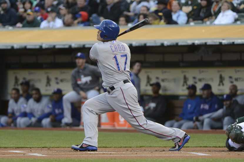 April 21, 2014; Oakland, CA, USA; Texas Rangers left fielder Shin-Soo Choo (17) hits a solo...
