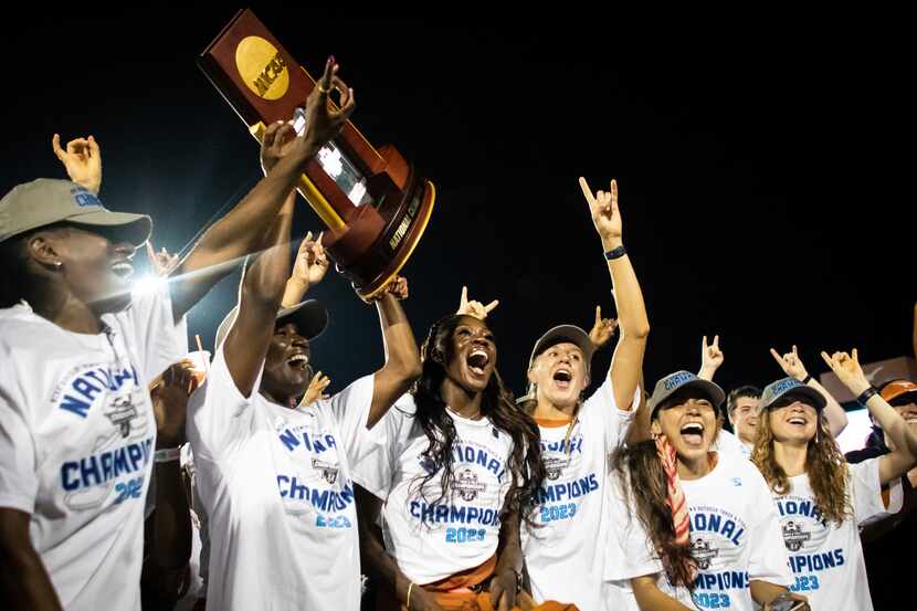Texas players celebrate after winning the NCAA outdoor track and field championships as they...