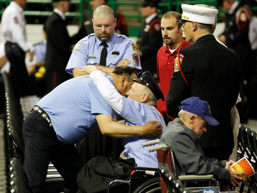 West firefighters console each other before a memorial service for first responders who died...