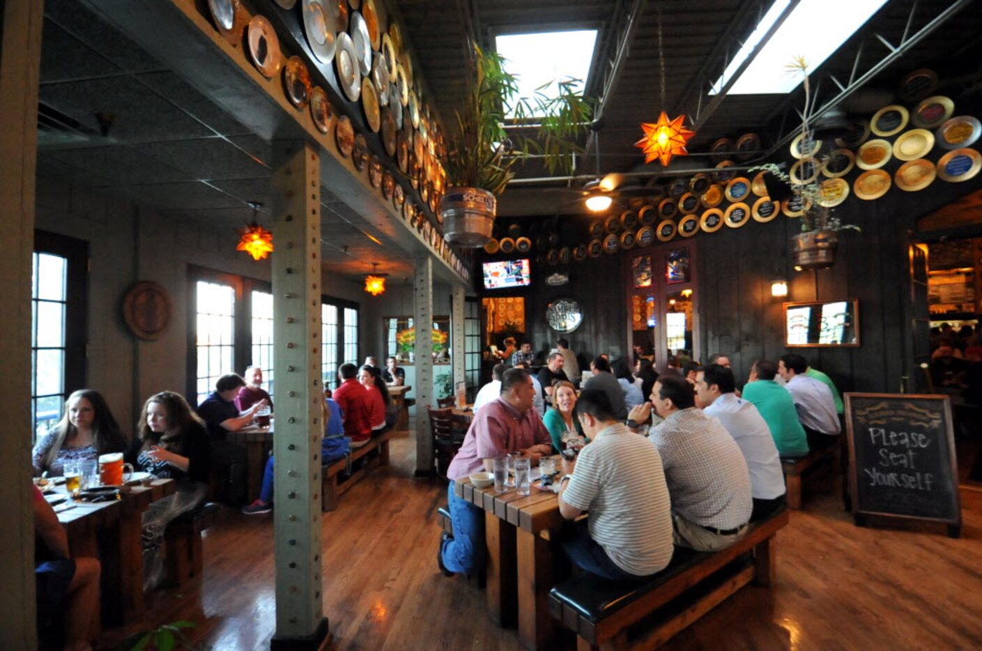 Guests sit at the tables and order beer and food at the beer-hoisting competition at Flying...