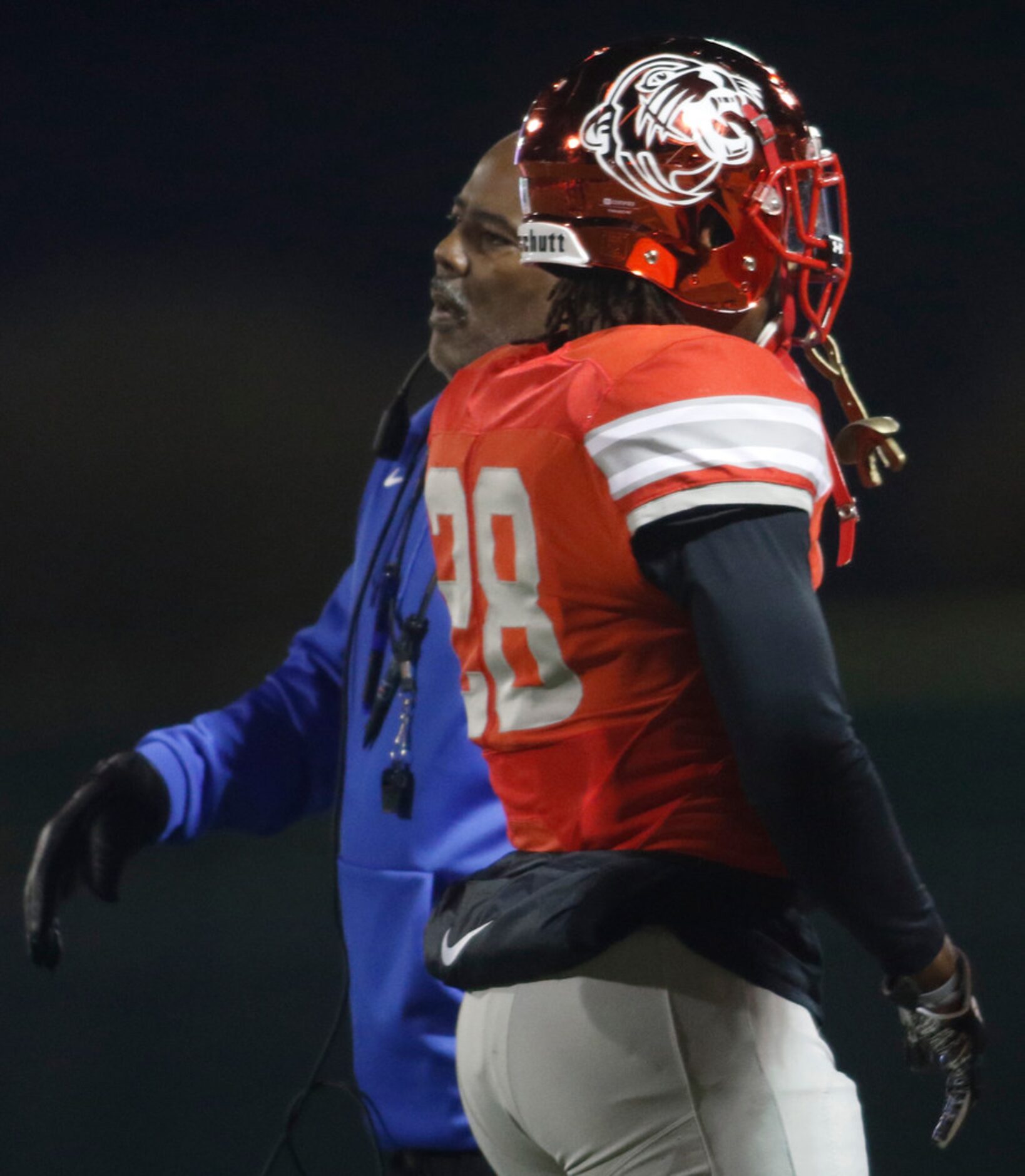 Duncanville Panthers head coach Reginald Samples greets players following a change of...