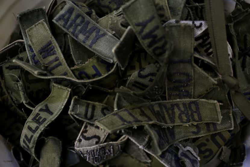 Military name patches rest in a box at the Recon Militaria store that specializes in selling...