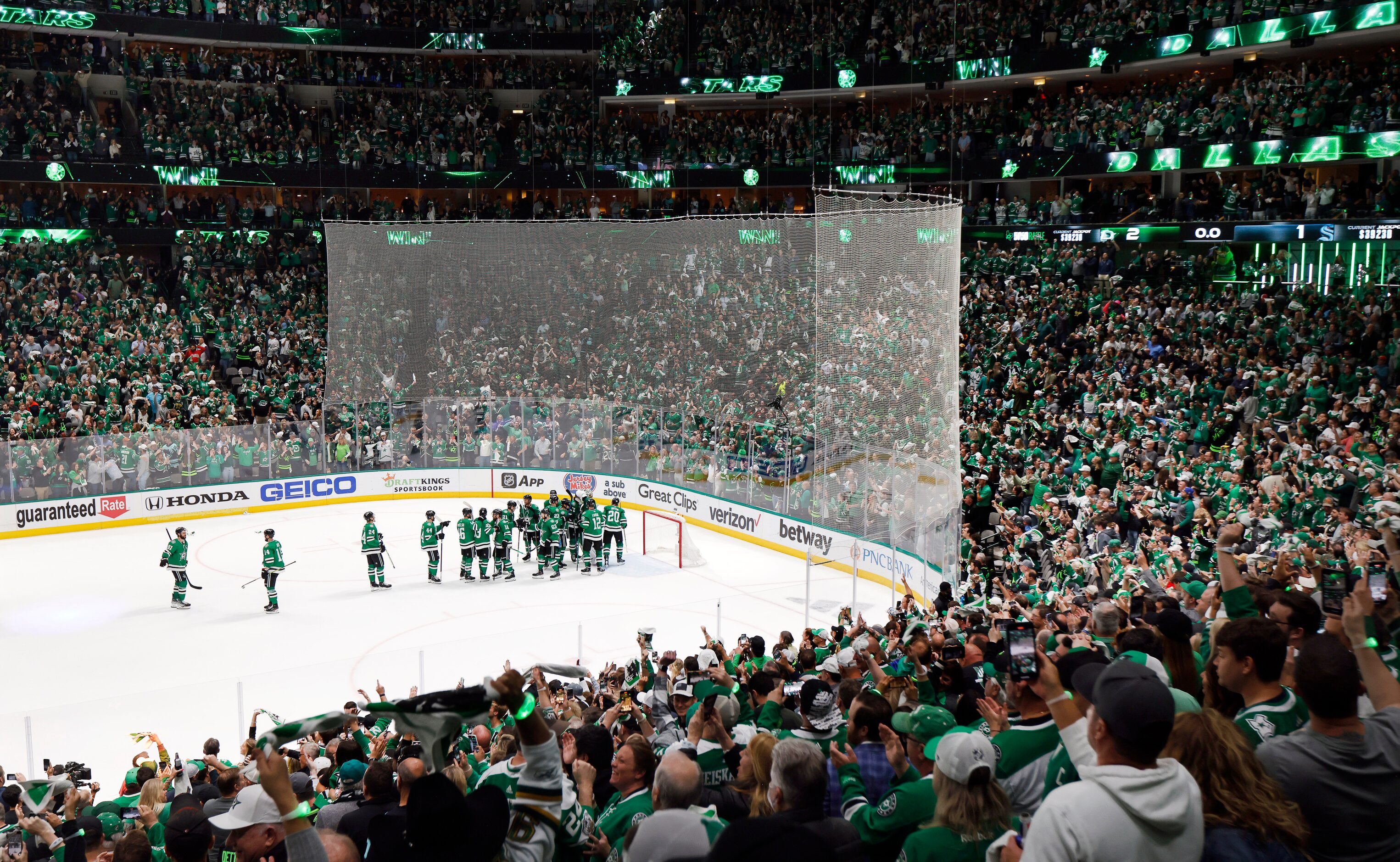 Dallas Stars players congratulate one another as fans celebrate their series win over the...