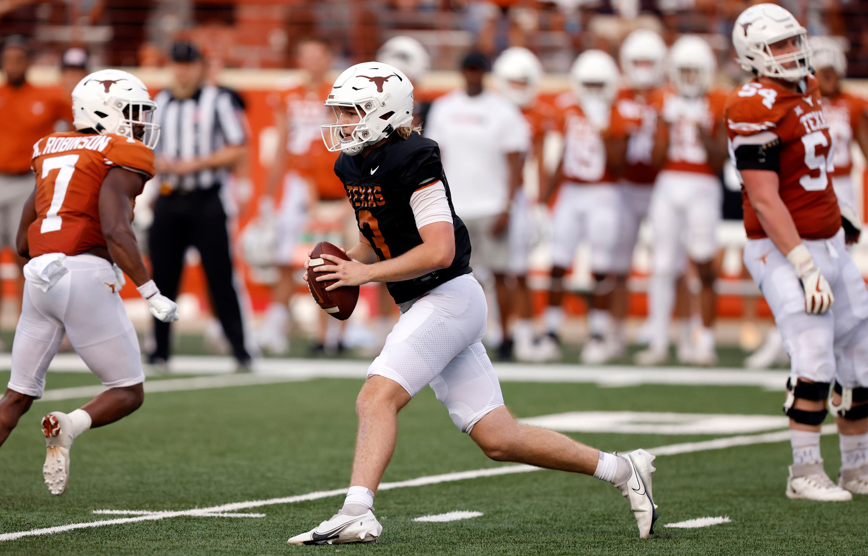 Texas Longhorns quarterback Quinn Ewers scrambles from the pocket before throwing during the...