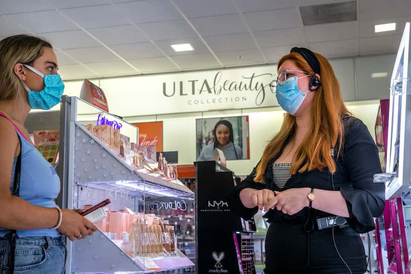 Co-manager Samantha Corral (right) helps Alex Coulson pick out makeup products at Ulta Beauty.