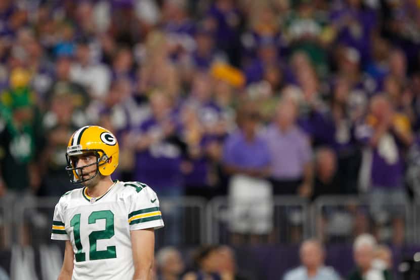 Green Bay Packers quarterback Aaron Rodgers stands on the field during the first half of an...