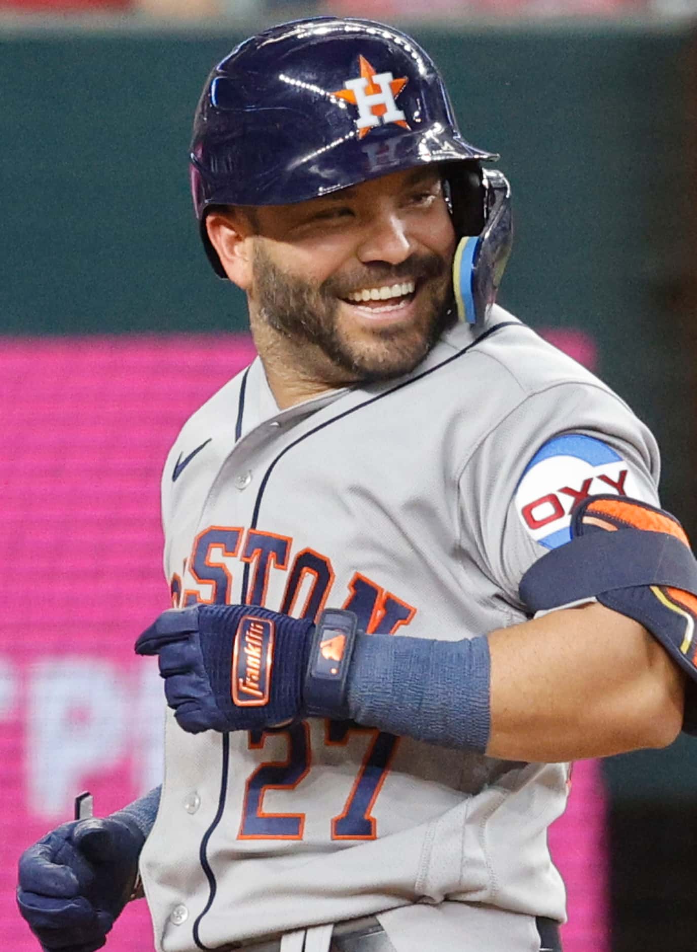 Houston Astros second baseman Jose Altuve (27) comes back the home plate with smile after...