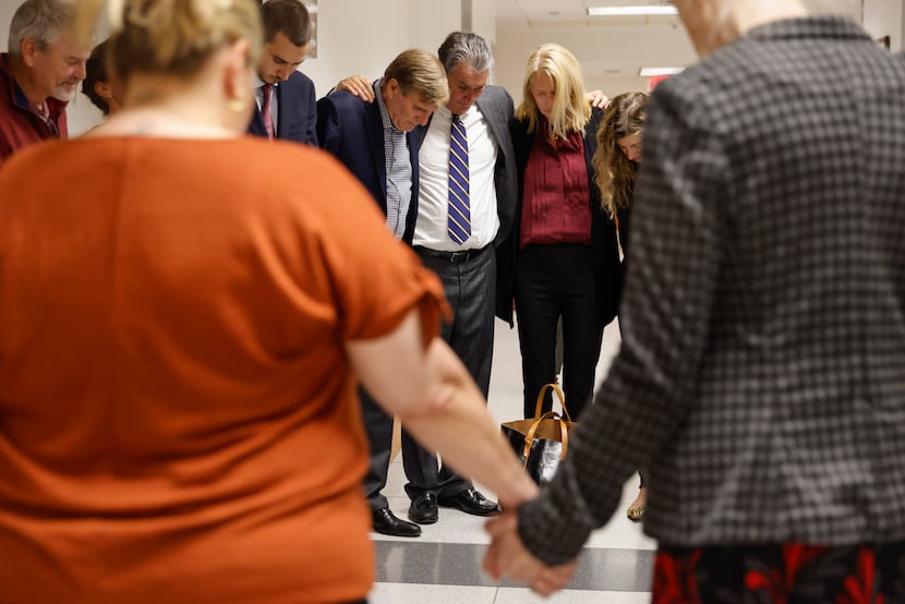 Friends and family members of deceased Jonathan Crews pray after his former girlfriend...