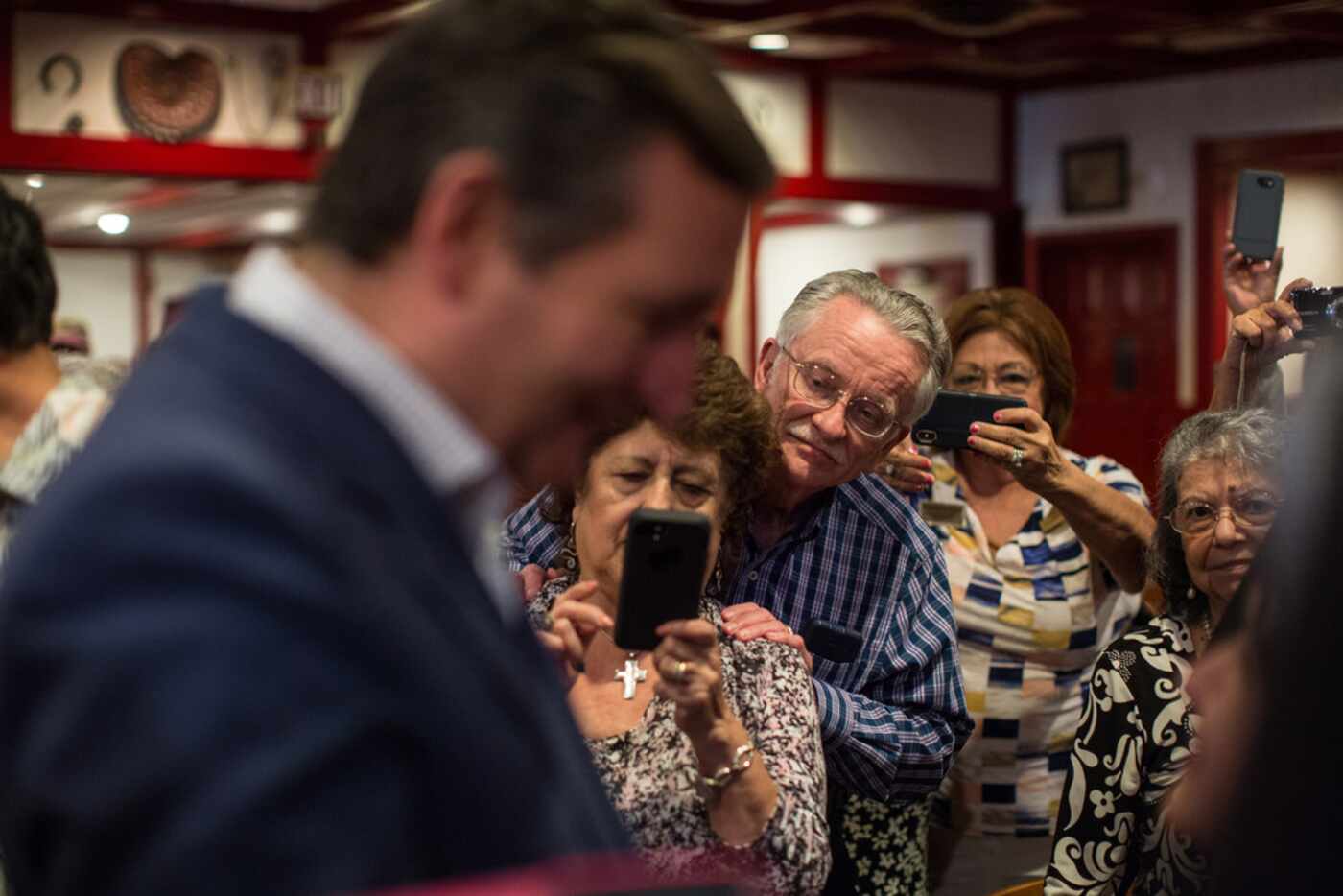 People wait in line to meet Sen. Ted Cruz in San Antonio as he campaigns for re-election.