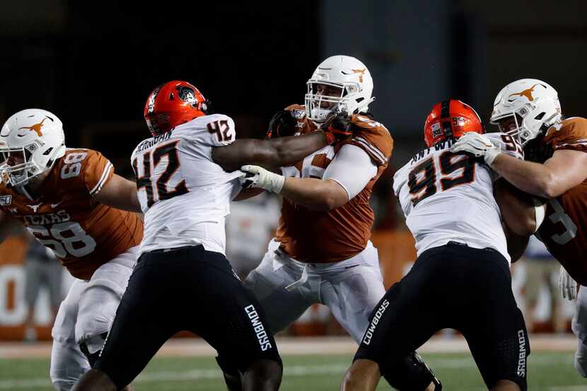 Texas offensive lineman Zach Shackelford (56) battles with Oklahoma State defensive tackle...