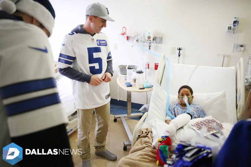 Dallas Cowboys kicker Dan Bailey speaks with Xavier Sanford, 9, f Dallas, during a visit to...