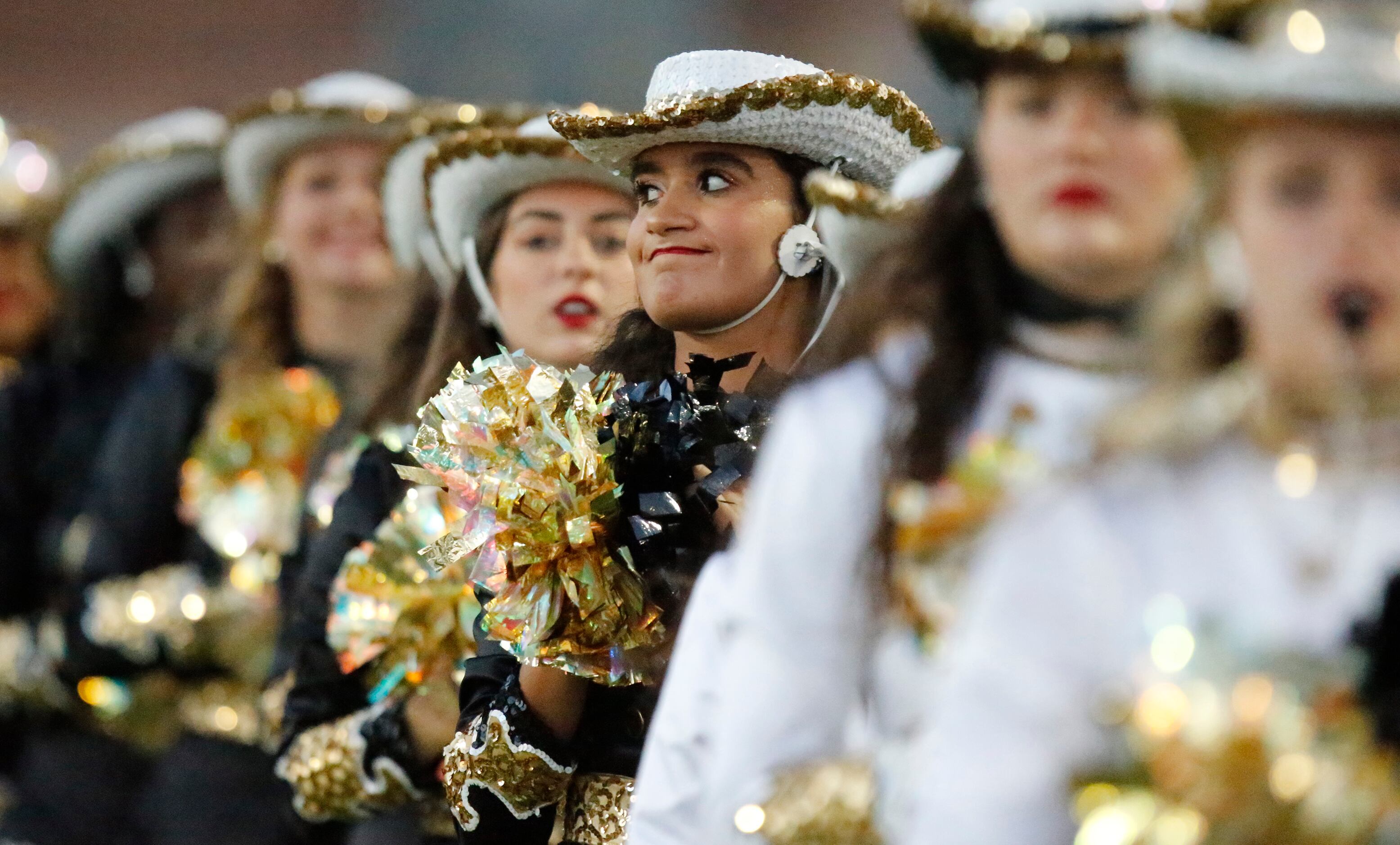 Plano East High School Golden Girl Liana Bezada stands at attention before her team entered...