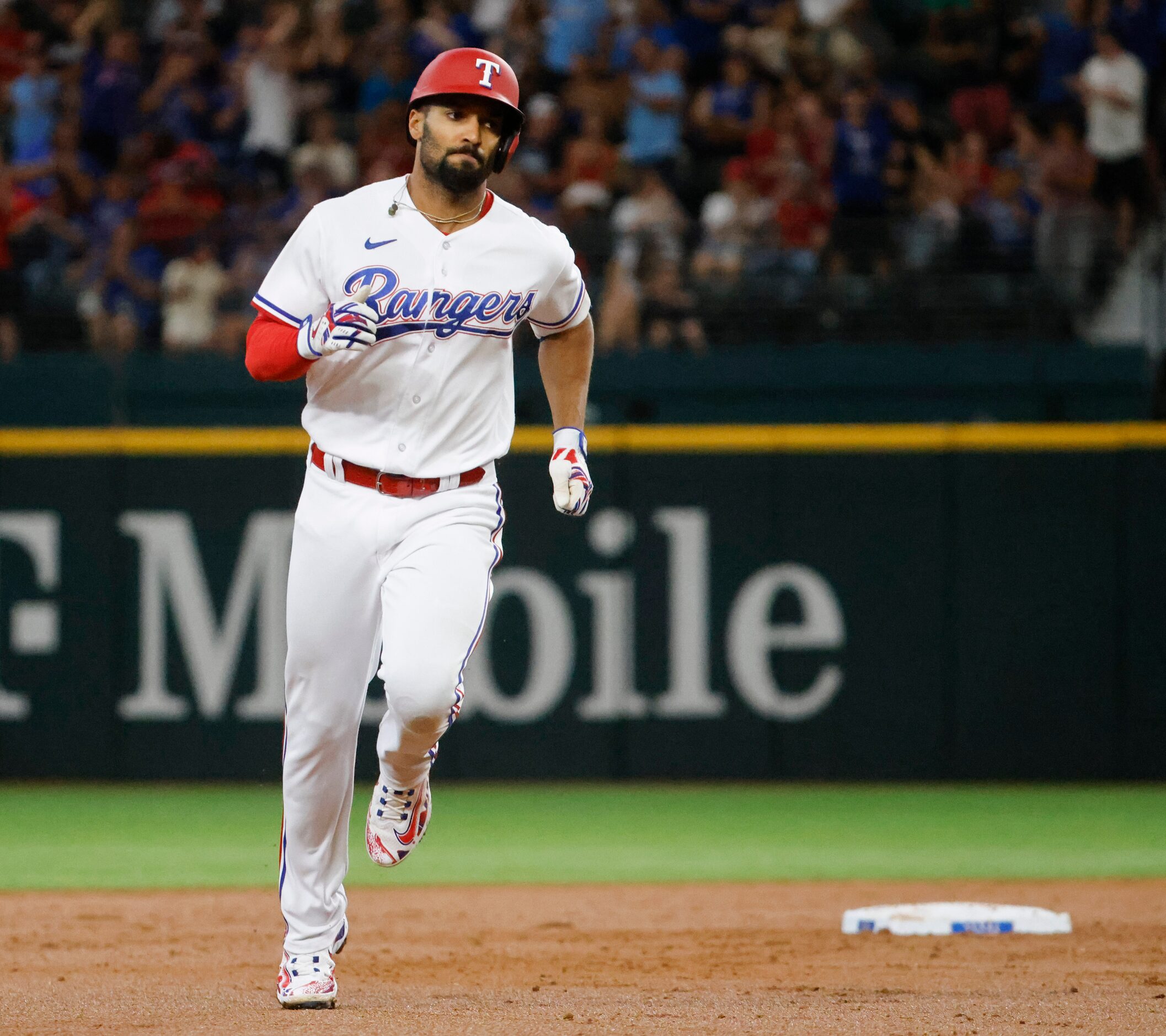 Texas Rangers second baseman Marcus Semien runs between bases after a homer during the third...