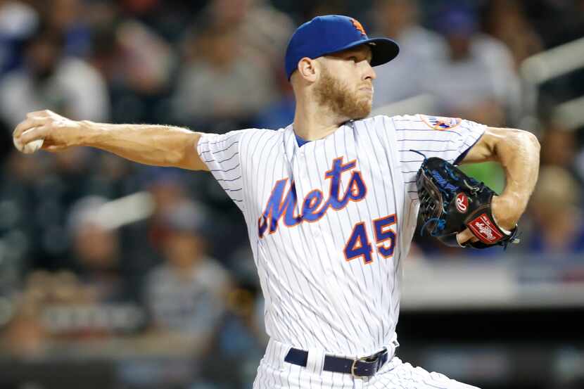 New York Mets starting pitcher Zack Wheeler (45) winds up during the first inning of a...