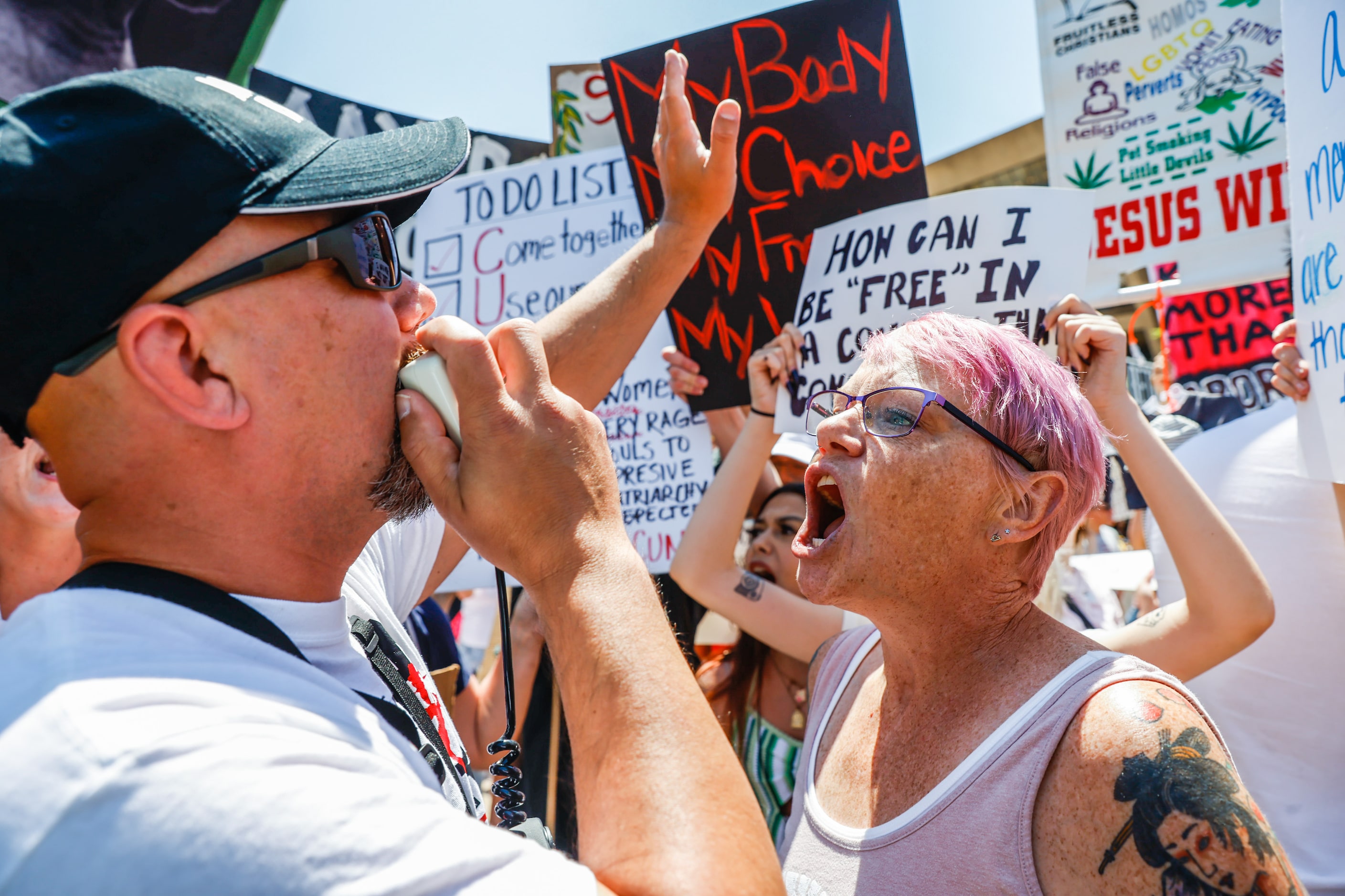 Abortion rights supporters and opponents clash while demonstrating in downtown Dallas on...