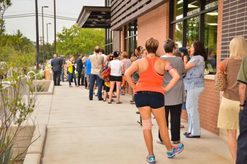 
Patrons form a long line outside the new Trader Joe's grocery store location on Lower...