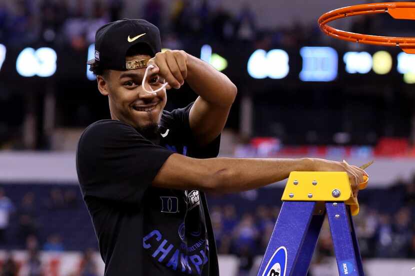 INDIANAPOLIS, IN - APRIL 06:  Quinn Cook #2 of the Duke Blue Devils cuts down the net after...