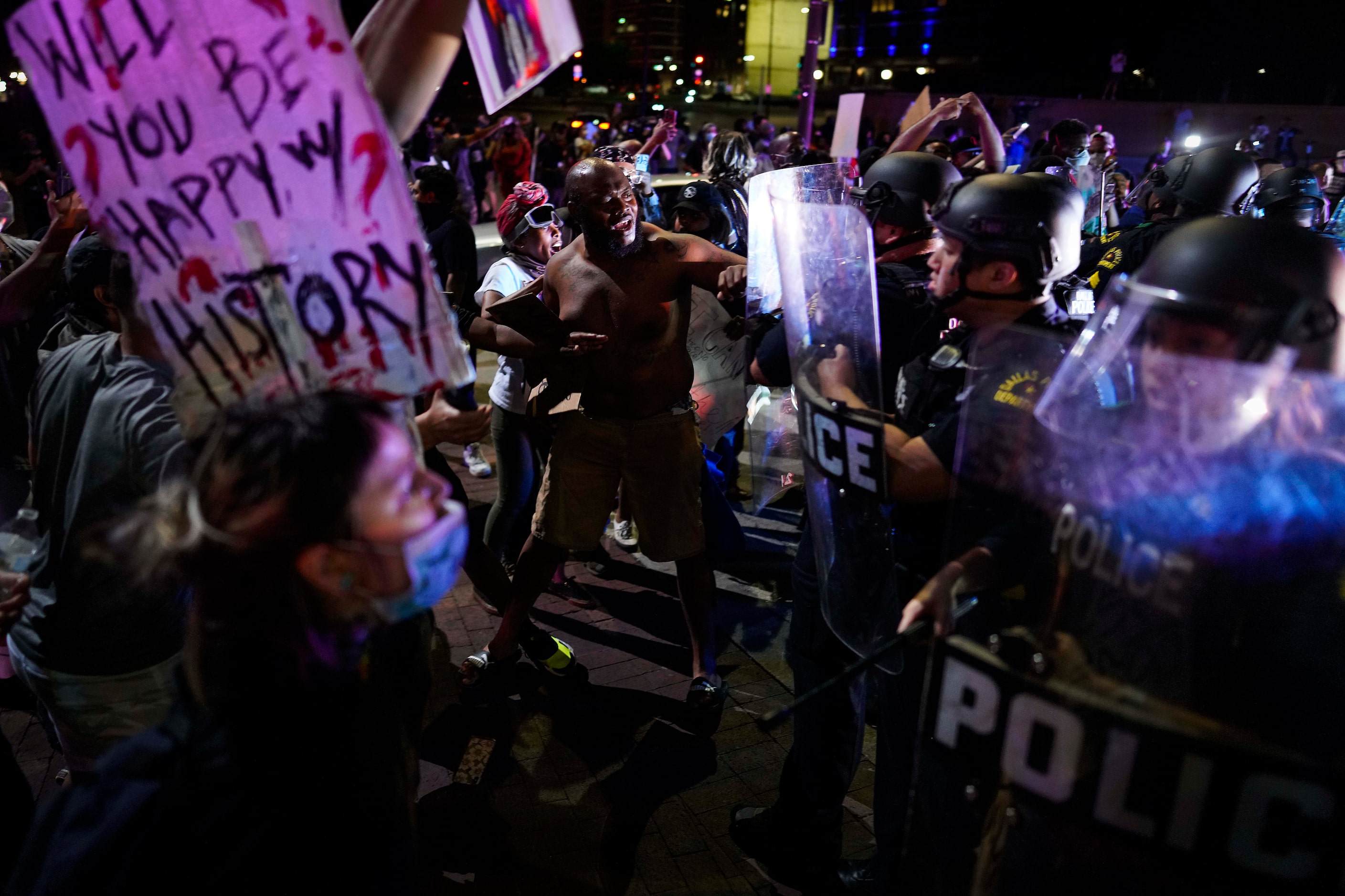 Dallas police clash with protesters at the corner of of Griffin and Young Streets as they...