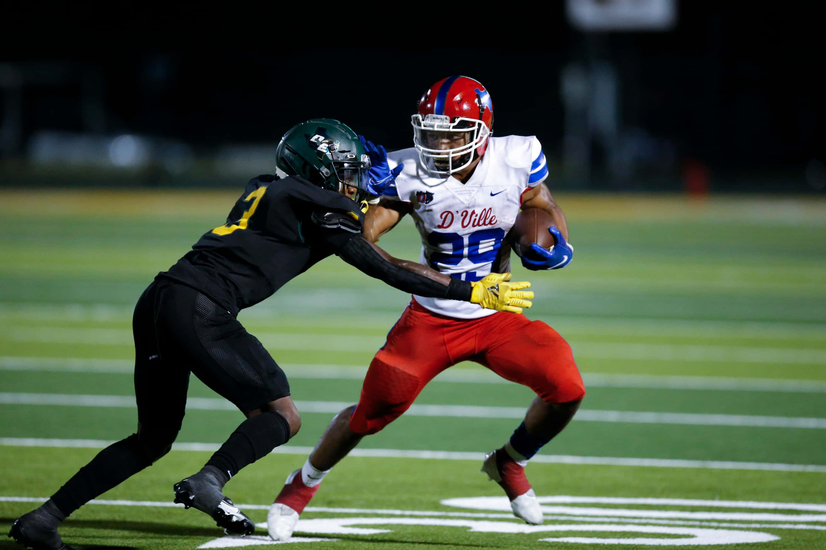 Duncanville sophomore running back Caden Durham (29) looks for room against DeSoto senior...