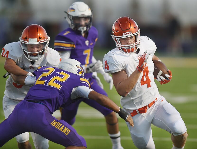 Sanger defensive back Elijah Ritzel (22) fights off a block trying to tackle Celina running...