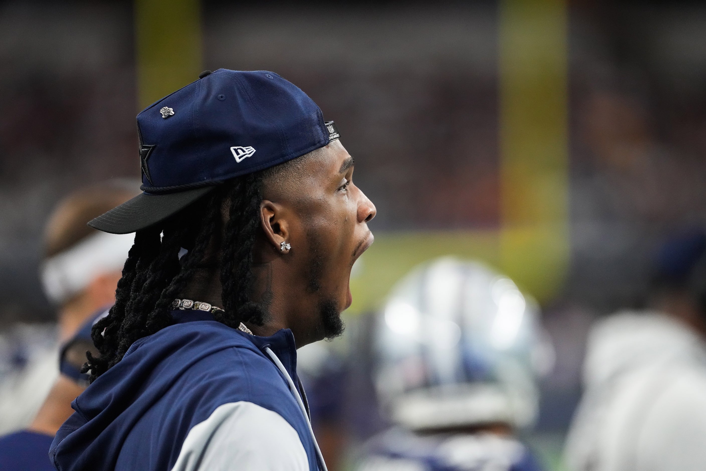 Dallas Cowboys wide receiver CeeDee Lamb yawns while watching from the sidelines during the...