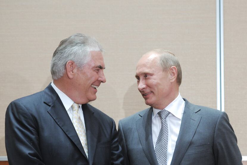 Russia's Prime Minister Vladimir Putin, right, speaks with Exxon Mobil President and CEO Rex...