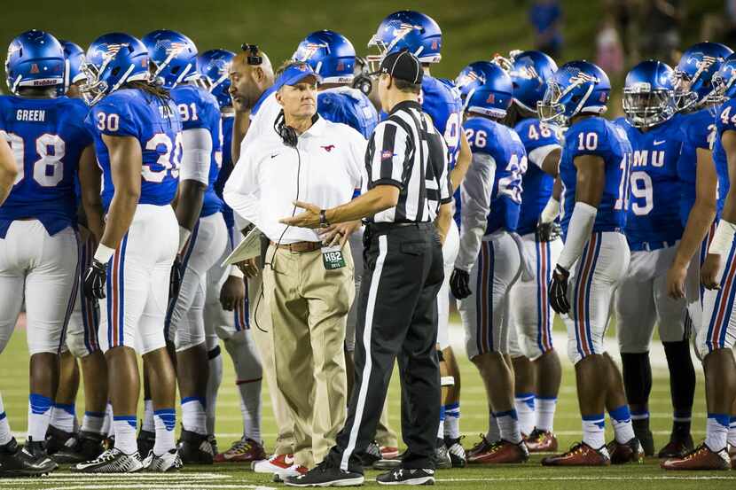SMU head coach Chad Morris talks with an official during a timeout in the second half of an...