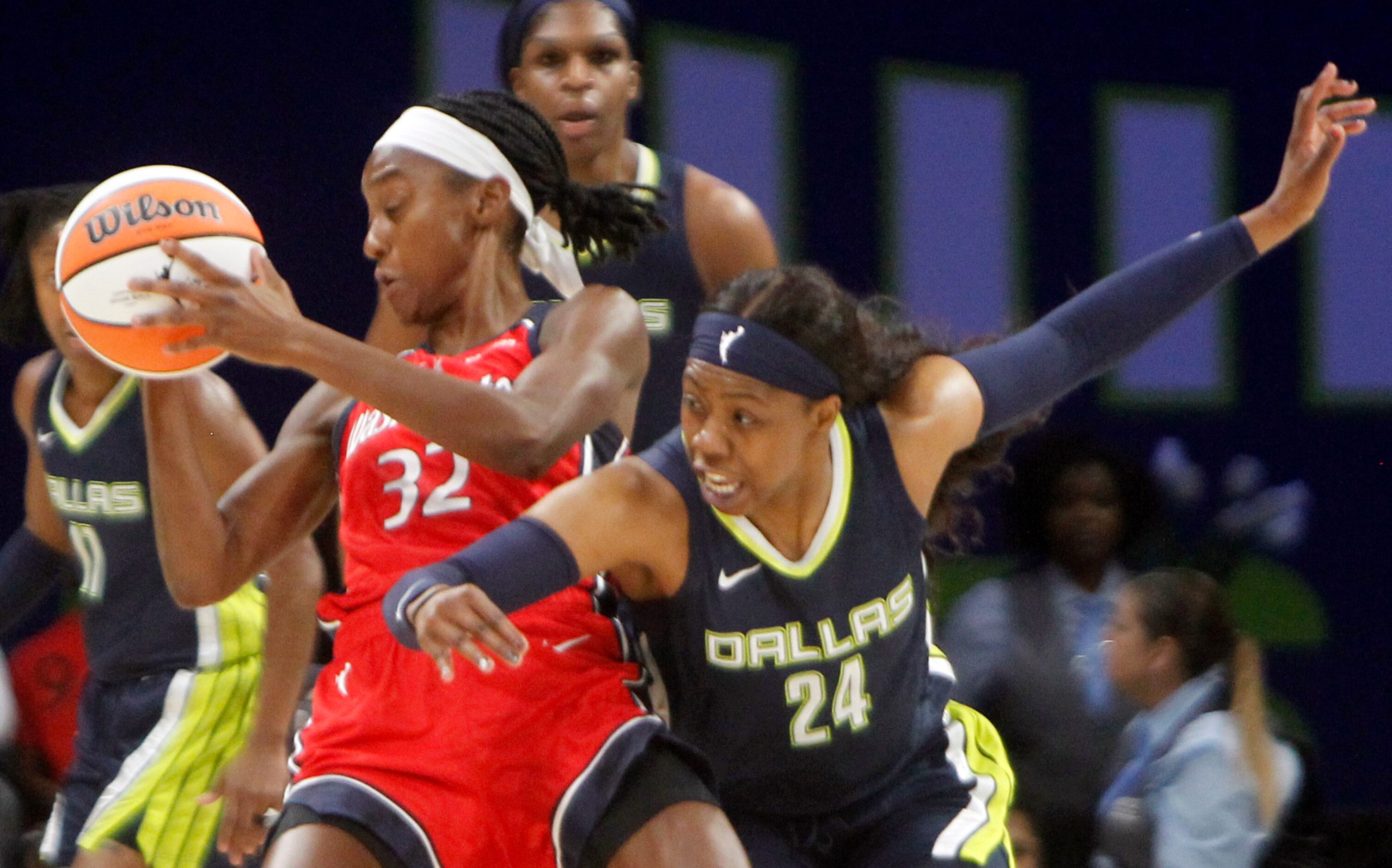 Dallas Wings guard Arike Ogunbowale (24), right, lunges defensively in an attempt for a...