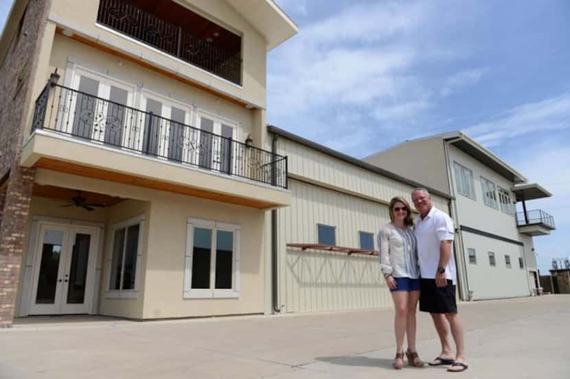 
Mike Shell and his wife, Shannon Shell, stand in front of their town home development, Aero...
