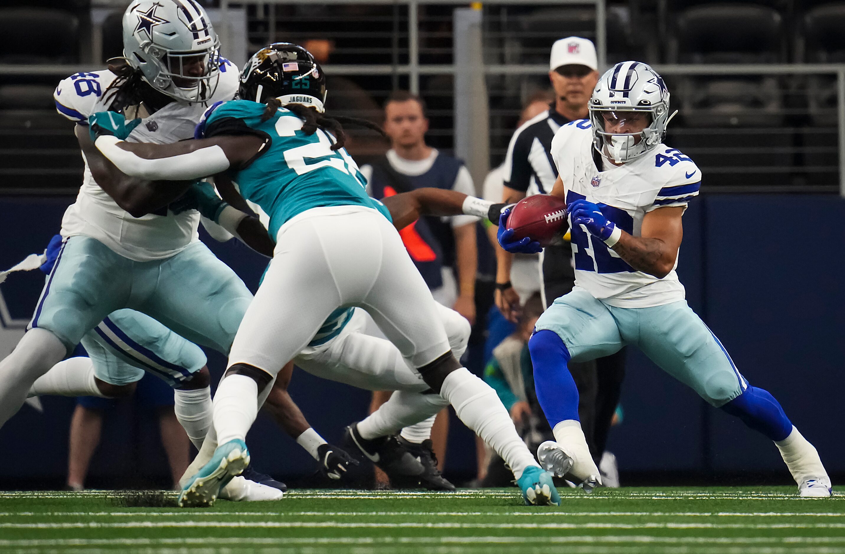 Dallas Cowboys running back Deuce Vaughn (42) returns a kick during the first half of an NFL...