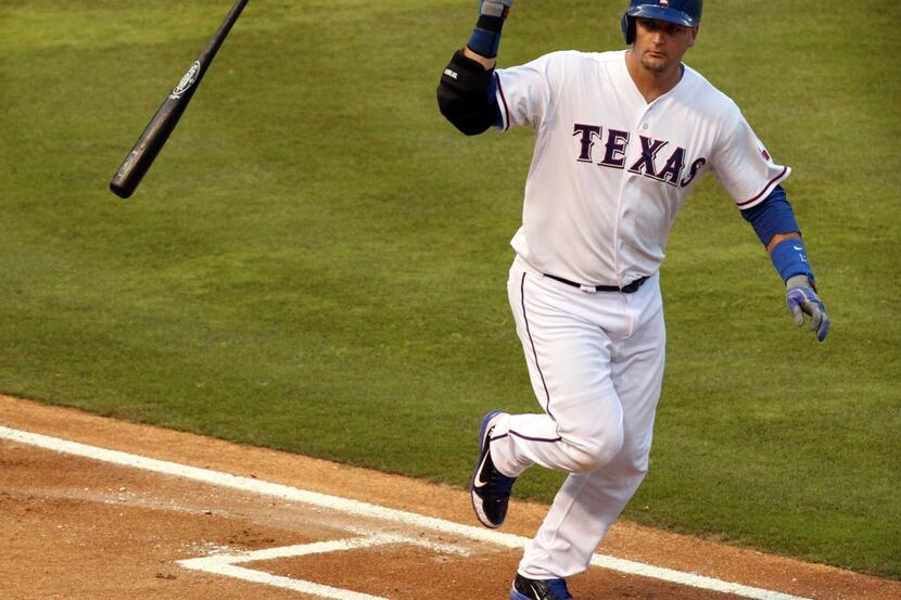 Texas Rangers catcher A.J. Pierzynski (12) flips his bat away after hitting a second-inning...