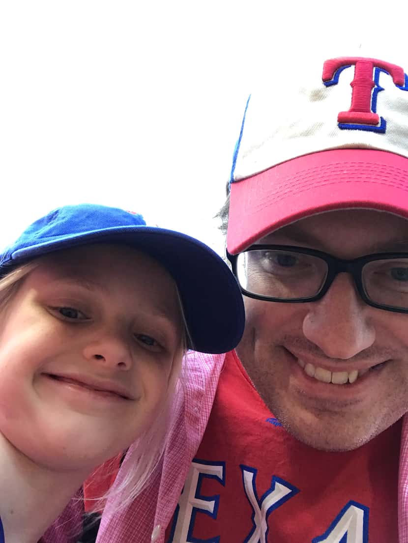 Maggie and Joshua Whitfield take in a Texas Rangers baseball game.